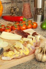 Baked chicken breast with cheese, mustard and vegetables. Preparing diet meals. Preparing chicken for roasting.
