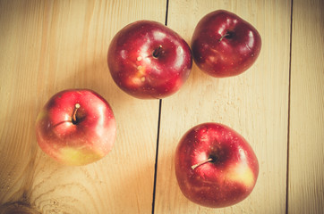 Fresh organic apples on wooden background.