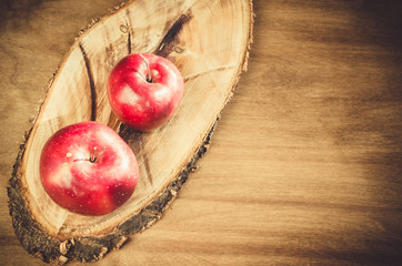Fresh organic apples on wooden background.