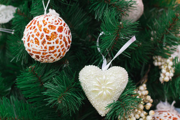 Christmas tree with orange ball and white heart ornaments