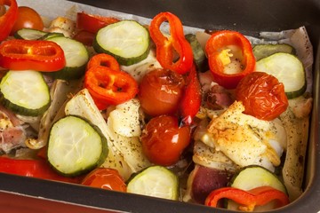 Baked chicken breast with cheese, mustard and vegetables. Food from the oven. Finished diet food.
