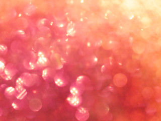 Festive background blur with glare. Red, pink, yellow.