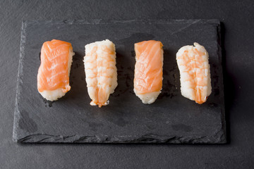 Pieces of sushi on a black stone