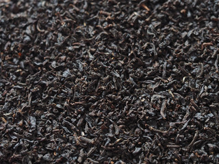 Black tea background, dried tea leaves