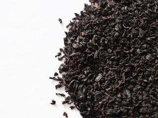 Black tea background, dried tea leaves isolated on the white background - obrazy, fototapety, plakaty