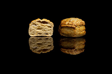 Two small cornbread isolated on black background