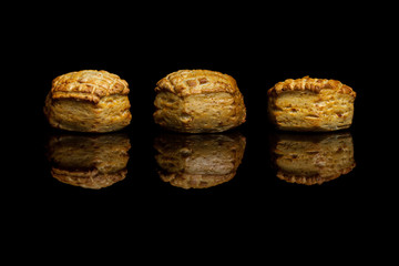 Three small cornbread isolated on black background