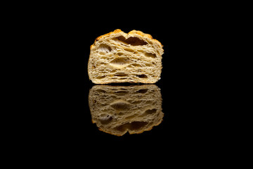 Half of a small corn bread isolated on black background