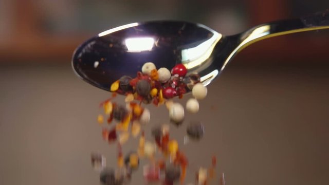 Spices are poured from a spoon