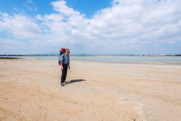 Bearded man, hiker dreaming on coast of Larnaca salt lake