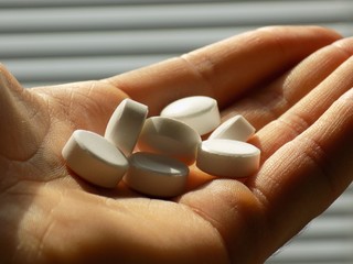 Pills on men hand in psychiatry in hospital
