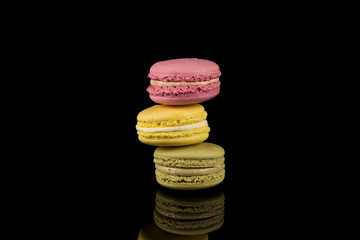Colorful macaroon over black background