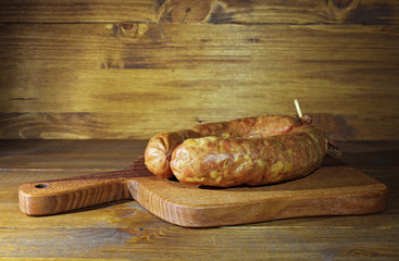 Raw homemade Kranjska sausages on wooden background