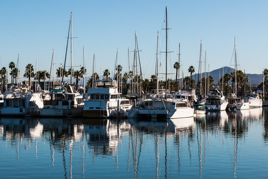 Boats moored in bay at the Chula Vista Bayfront park with mountain peak in the background.