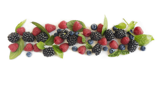 Various fresh summer berries. Ripe blueberries, raspberries and blackberries. Berries on white background. Top view