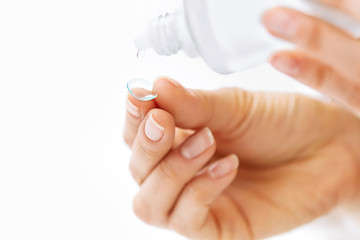 Woman Hand With Contact Eye Lens And Cleansing Solution