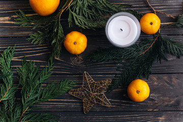 stylish christmas flat lay with green branches and oranges on bl