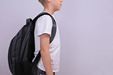 School child with backpack. Good posture concept.