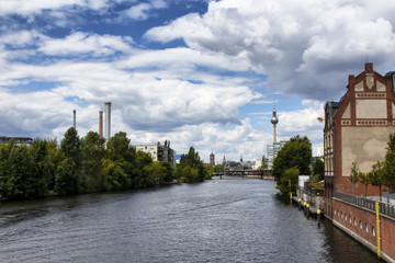 Berlin city view from a bridge on Spree river. Cloudy, dramatic sky is in the view