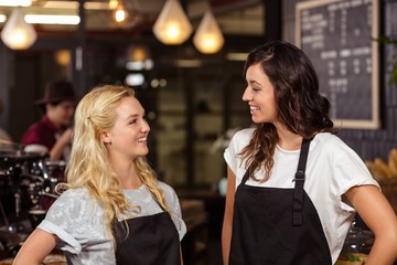 Pretty waitresses posing in front of the counter