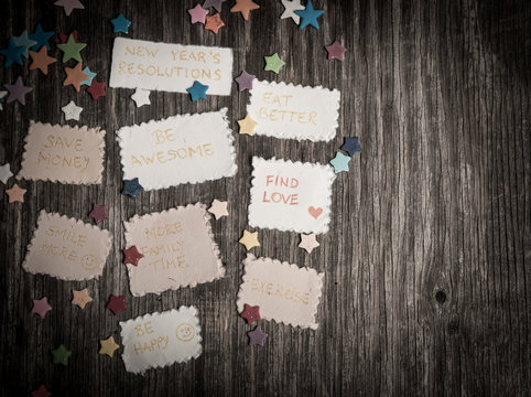 New Year goals or resolutions with decorations on rustic wooden background