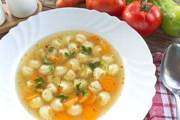 Soup with meatballs and pasta in plate