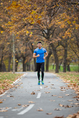 Obraz premium Athletic young man running in the nature. Healthy lifestyle