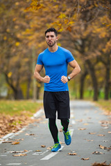 Fototapeta premium Athletic young man running in the nature. Healthy lifestyle