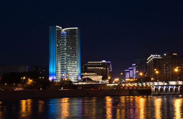 Fototapeta na wymiar house with blue illuminated on river bank