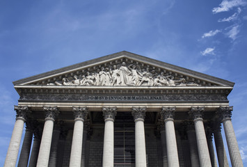 Bottom view of Madeleine with blue sky background in Paris. Church & concert venue completed in 1842, conceived as a pantheon in honor of Napoleon's armies.