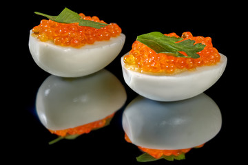 Boiled eggs with red caviar