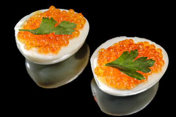 Boiled eggs with red caviar