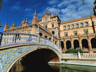 Gorgeous decorated bridge and stunning architecture against vivid blue sky at Plaza de Espana of Seville, Spain  © jobi_pro