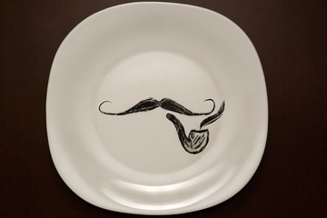 mustache and pipe on a plate