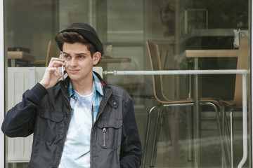 young with the telephone phone in the street of the city