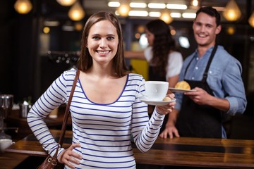 Smiling woman holding white cup