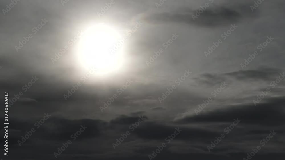 Wall mural dark and eerie clouds fill the sky with sun becoming more and more dim, time lapse.