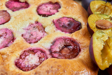 Home made plum buns on a wooden table