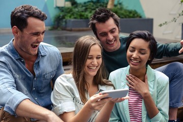 Fototapeta premium Happy friends using smartphone