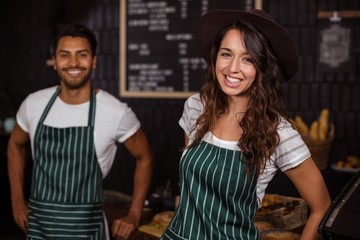 Smiling baristas looking at the camera