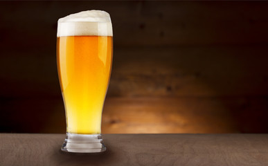 Glass beer on wood background