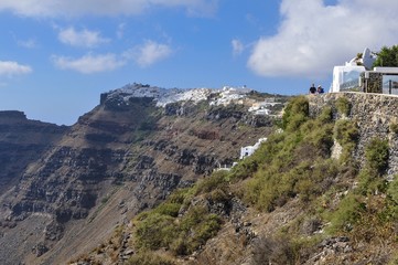 Fototapeta na wymiar Tourists Walk Beside Imerovigli, Santorini, Greece