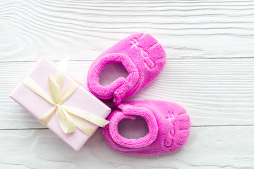pink baby's bootees on wooden background