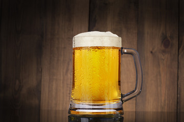 Glass beer on wood background with copyspace