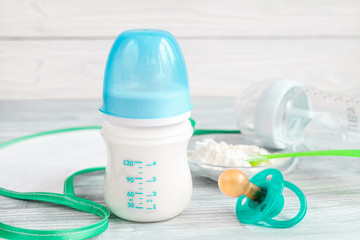 preparation of mixture baby feeding on wooden background