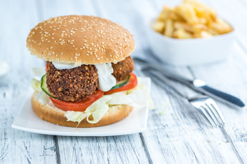 Wooden table with a Falafel Burger