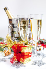 glasses of champagne and Christmas ornaments on white background
