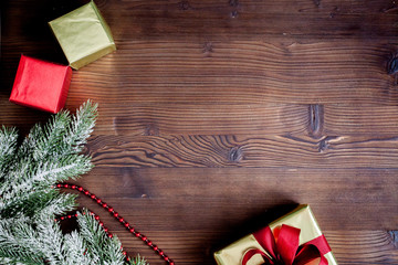 packaging christmas gifts in boxes on wooden background top view