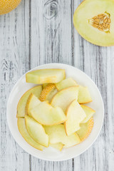 Portion of Honeydew Melon on wooden background (selective focus)