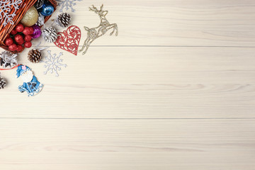Christmas background on wooden table with copyspace. Top view of xmas tree  pine cone and snowflake.  fir branch  silver balls.